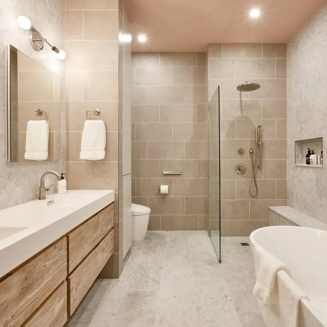 Bathroom renovation featuring a neutral color palette, contemporary finishes, and updated lighting.