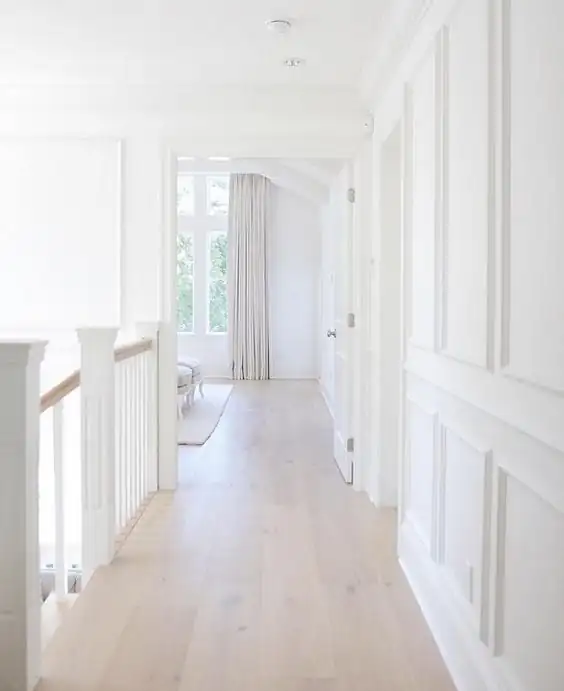 Hardwood flooring features visible grain and a consistent pattern across a clean, even installation.